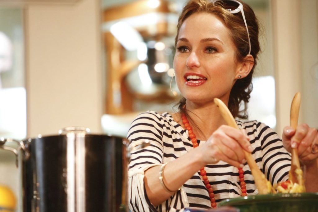 Food Network star Giada De Laurentiis wears a striped black and white blouse as she prepares a dish in 2010.