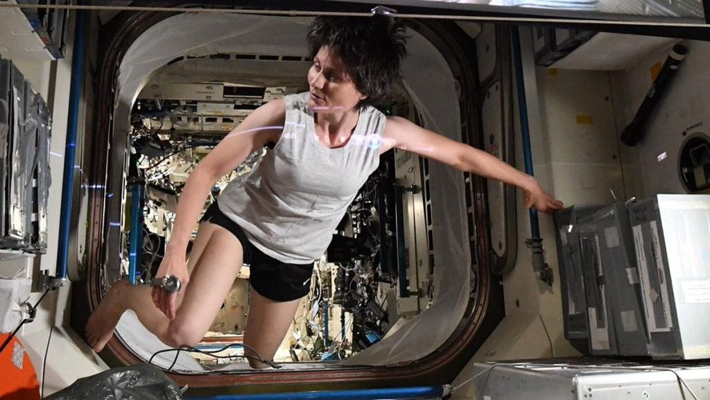 Cosplay di astronauta come personaggio della "gravità" spaziale in una ripresa della stazione spaziale